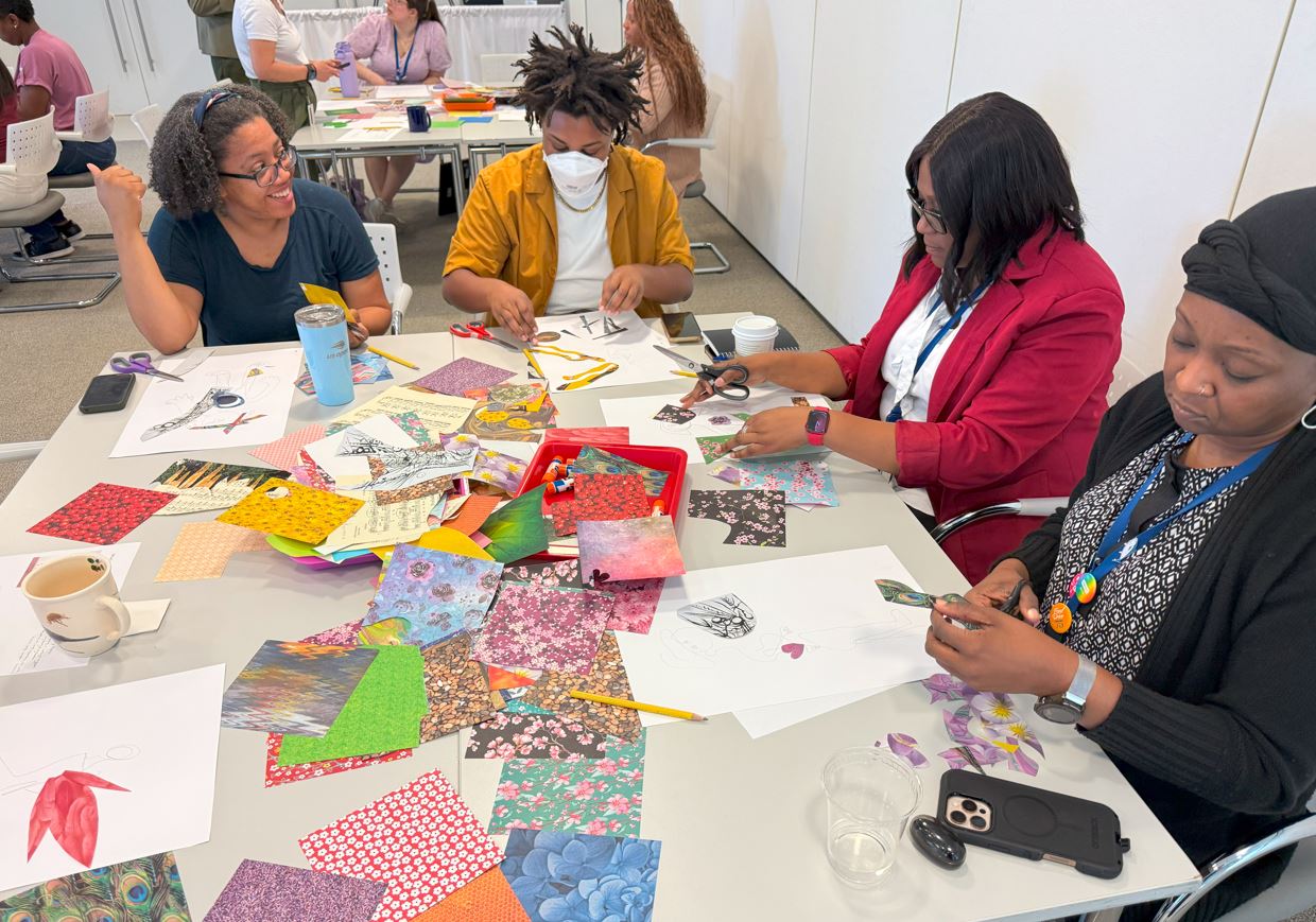 Four people sitting at a table making collages during Pew workshop
